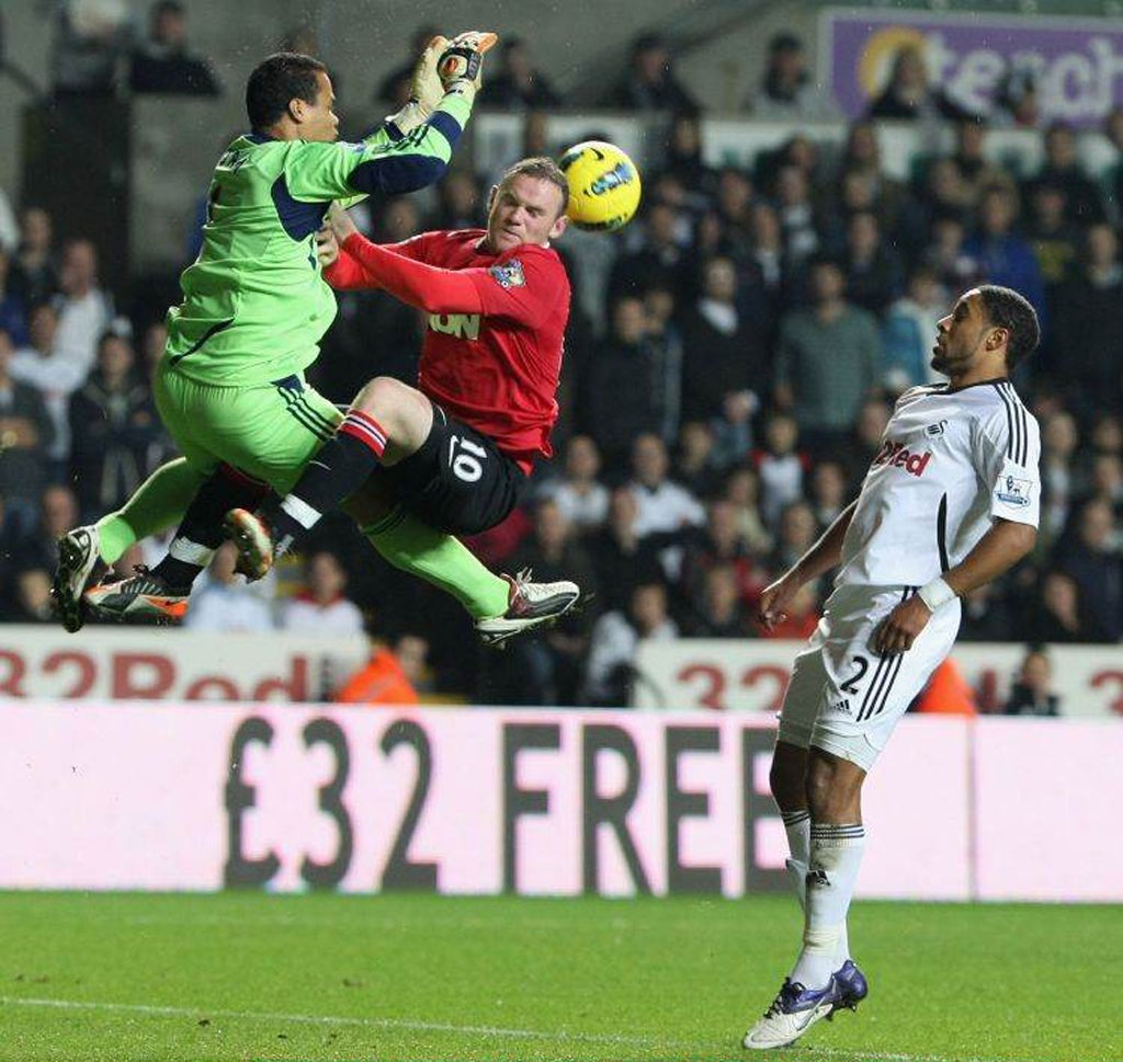 Swansea's Michel Vorm collides withWayne Rooney on a night when the hosts suffered an agonising miss