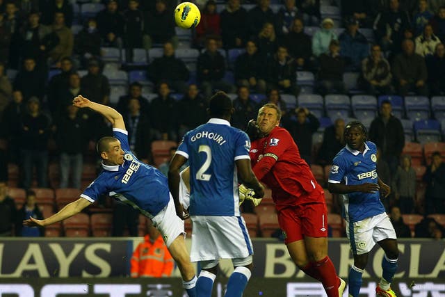 Paul Robinson, Blackburn’s goalkeeper, is kicked in the head by Wigan's David Jones to win a late penalty