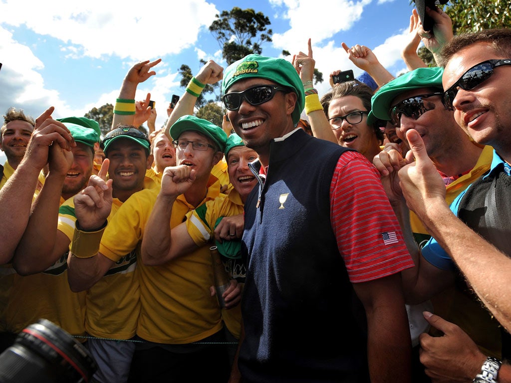 Tiger Woods celebrates with fans after winning for the US in Melbourne