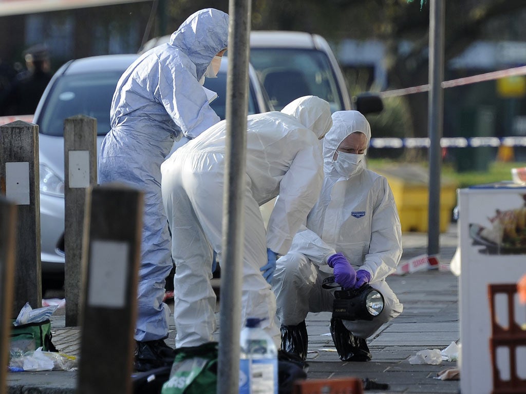 Forensics officers at work at the scene of the attacks in Kingsbury,
London