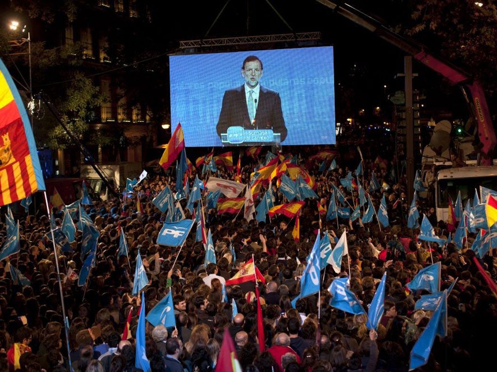 Supporters seen here as they cheer newly elected Prime Minister Mariano Rajoy's general election victory.