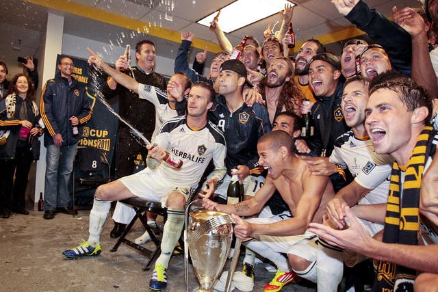 Los Angeles Galaxy midfielder David Beckham celebrates with his teammates after the Galaxy defeated the Houston Dynamo in the MLS Cup 