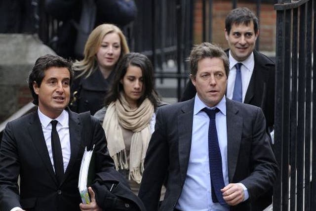 Hugh Grant arrives at the Leveson Inquiry at the High Court in London 