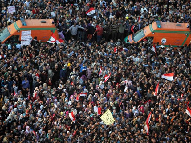 Protesters surround ambulances ferrying injured protesters after clashes with the army and riot police in Tahrir Square