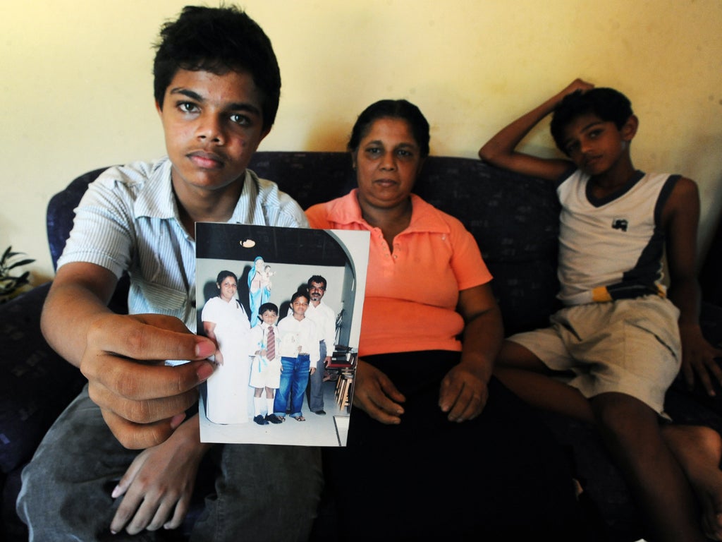 Harith Eknaligoda holds a picture that includes his missing father, the Sri Lankan journalist Prageeth Eknaligoda