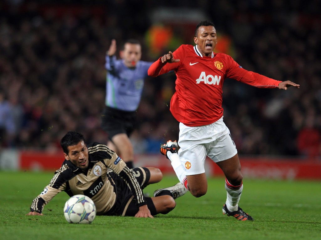 Nani goes flying during a hard fought game with Benfica