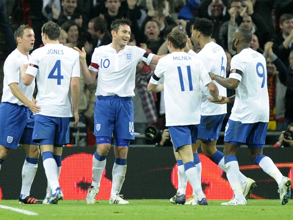 The England players celebrate their goal against world champions Spain