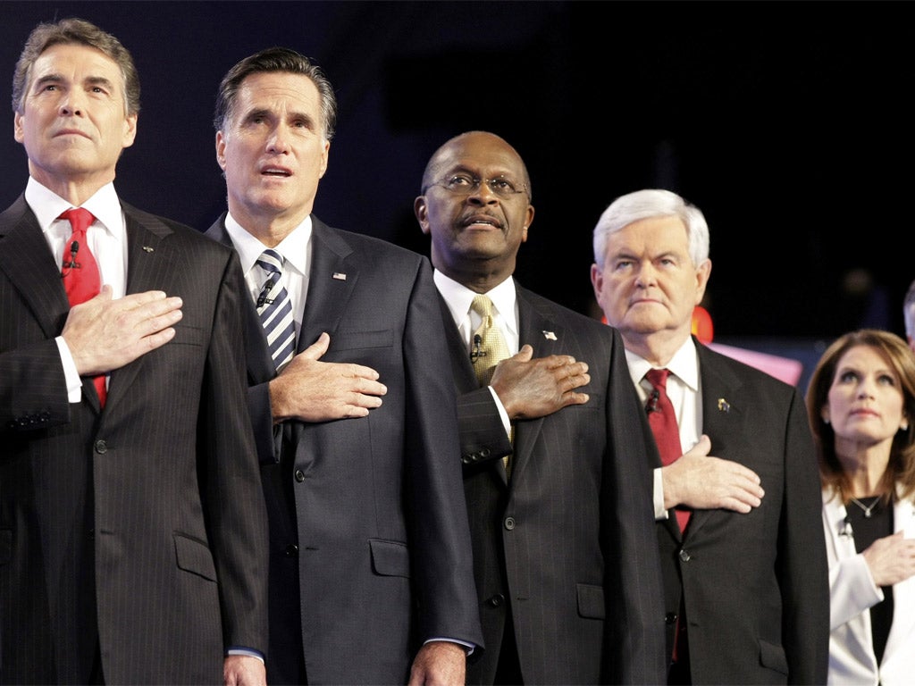Rick Perry, Mitt Romney, Herman Cain, Newt Gingrich and
Michele Bachmann stand for the national anthem