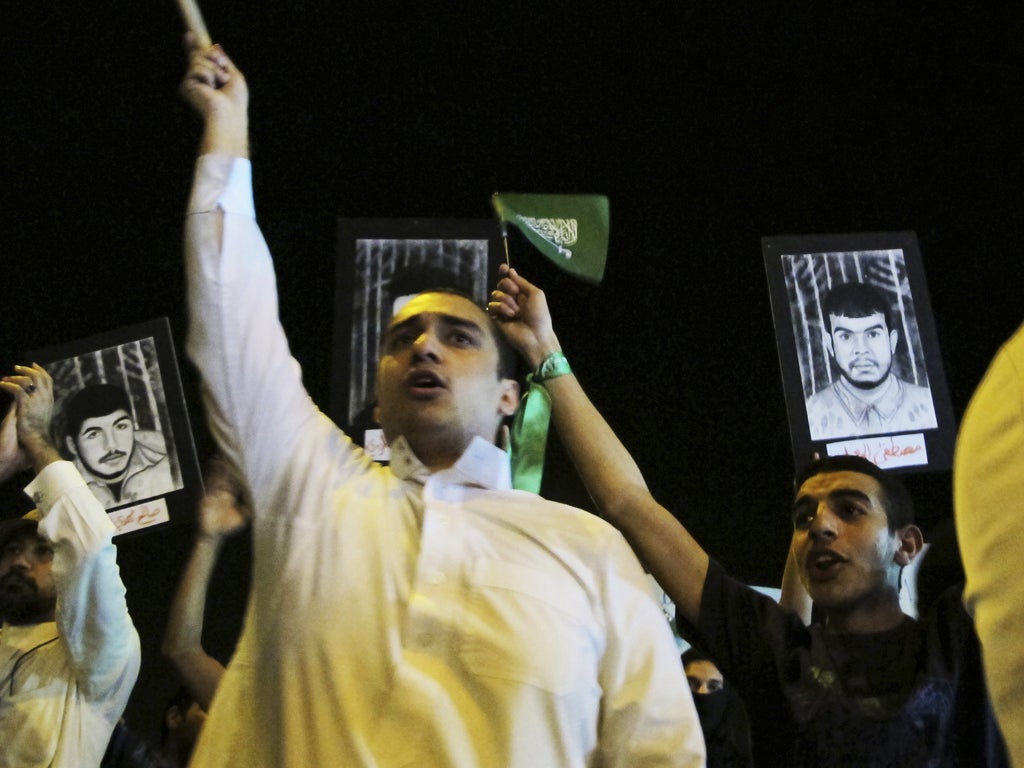 Shias hold flags and portraits of prisoners in Qatif earlier this year