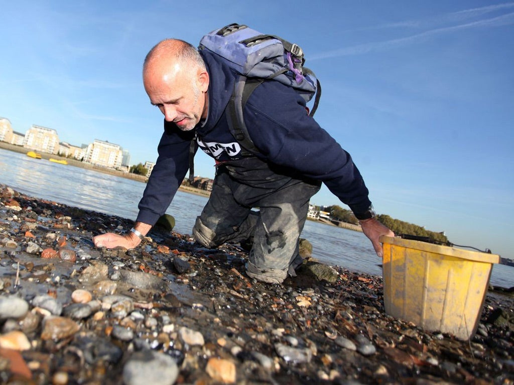 Steve 'Mud God' Brooker is pictured mudlarking for artefacts on the beaches of the river Thames at low tide.