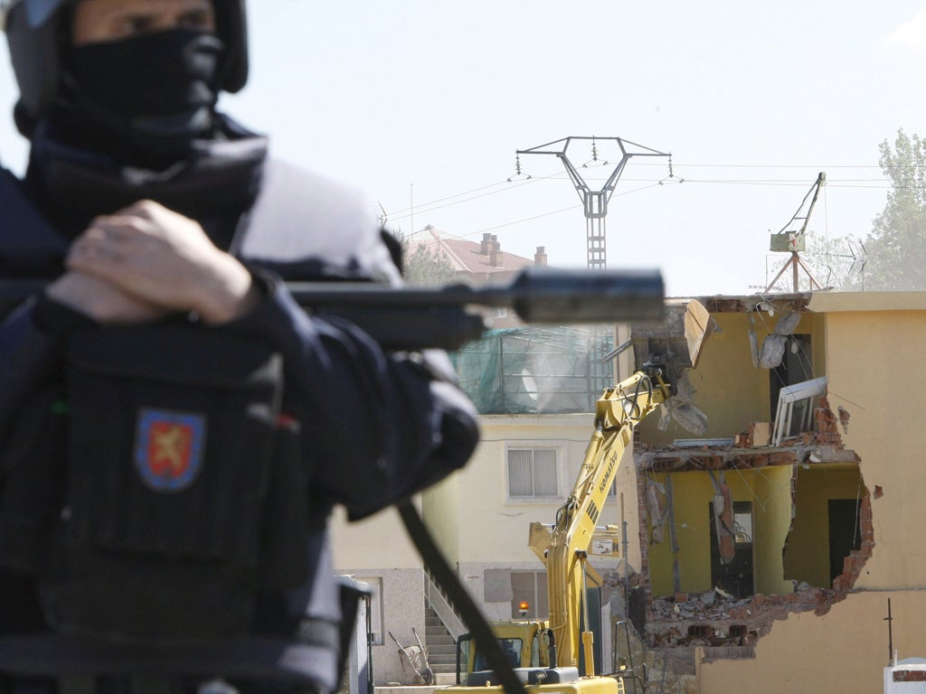 One of the over 400 police officers who kept watch over the pulling down of two evicted buildings in Canada Real Galiana near Madrid in 2008