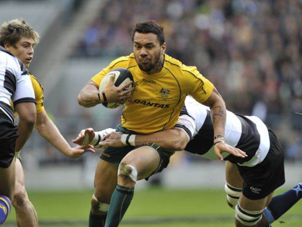 The Barbarians defence try to contain wing Digby Ioane, who scored two of the eight Wallaby tries
