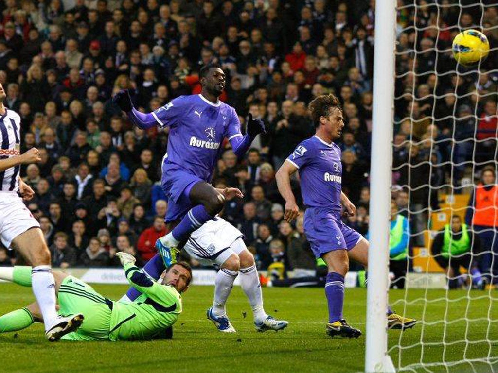 Tottenham's Emmanuel Adebayor (centre) follows up his own penalty to score the first of his two goals