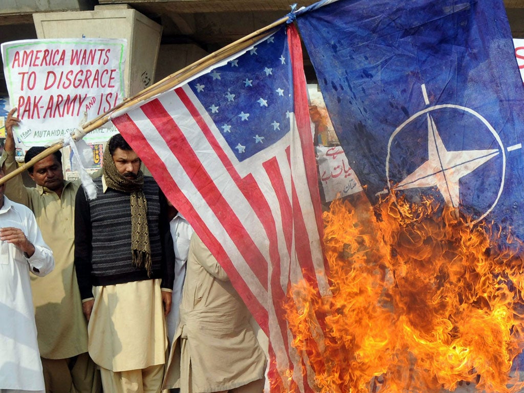 Pakistanis burn Nato and US flags in protest at the air strike
