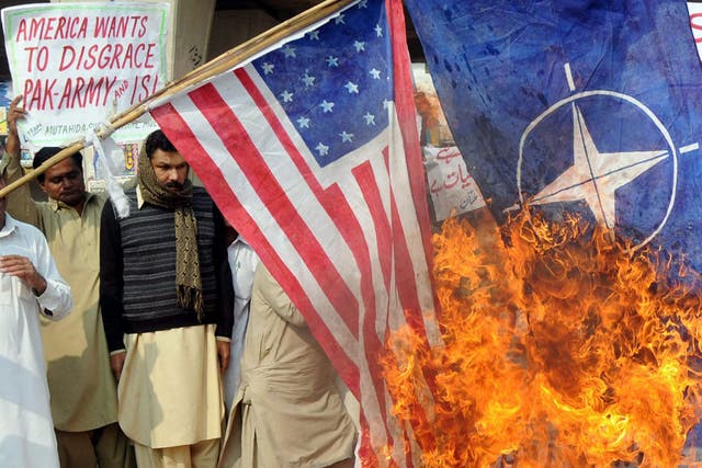Pakistanis burn Nato and US flags in protest at the air strike