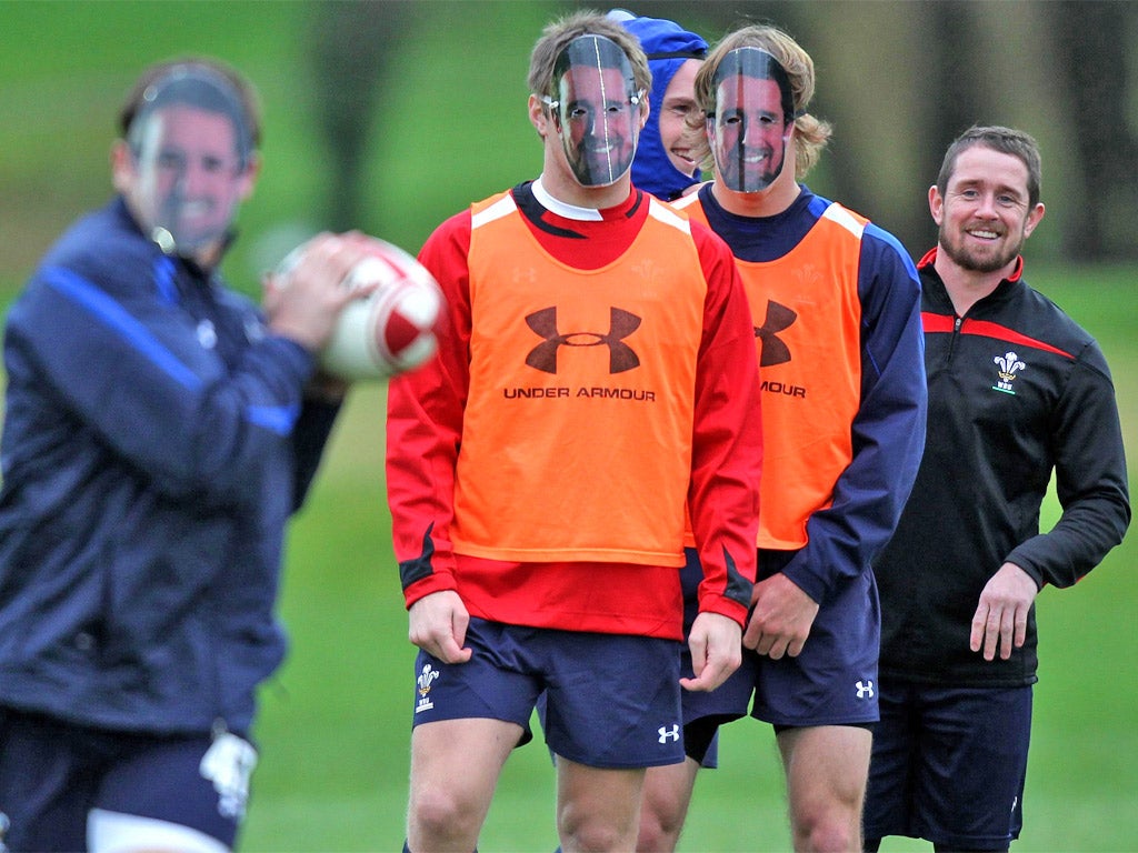 Shane Williams waits at the end of the queue watching his team-mates train in Shane masks yesterday