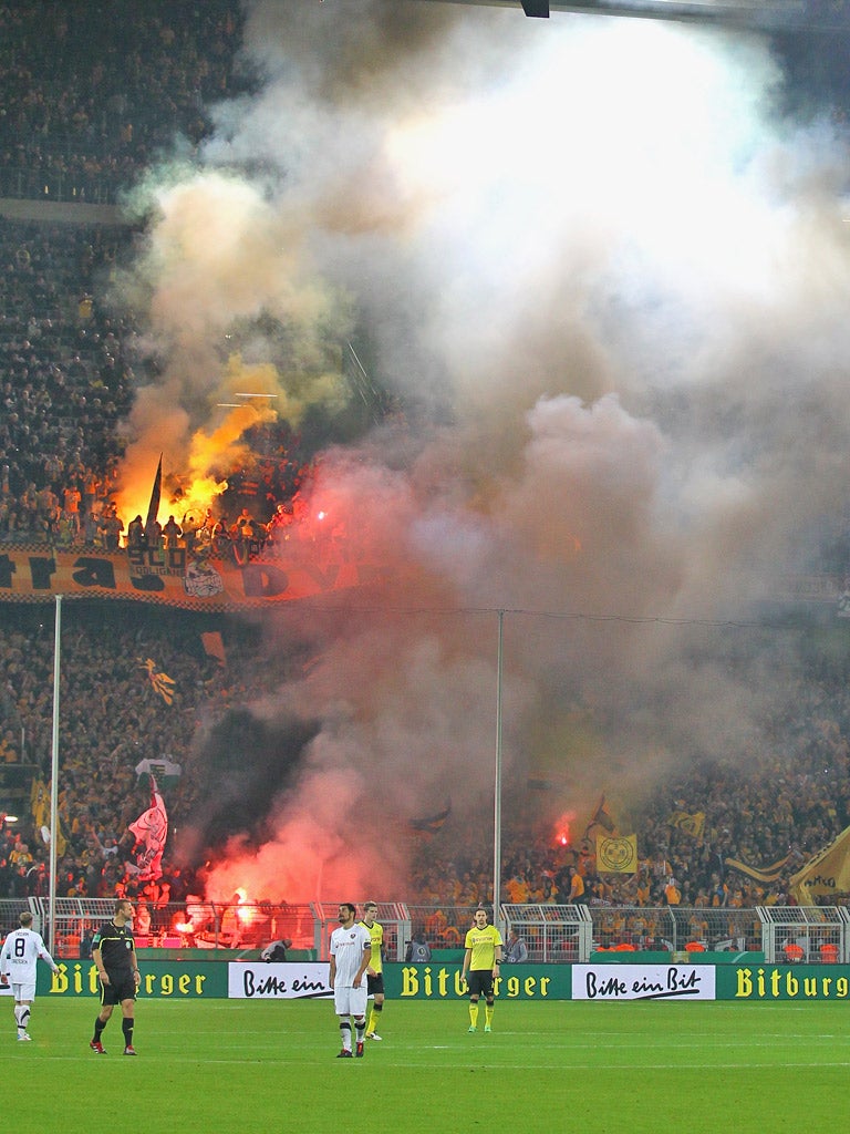 The referee makes one of three stoppages during the Cup match between Dortmund and Dresden last month