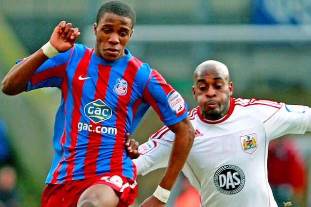 Palace's Wilfried Zaha (left) battles for the ball with Jamal Campbell-Ryce of Bristol City in the Championship at Selhurst Park
