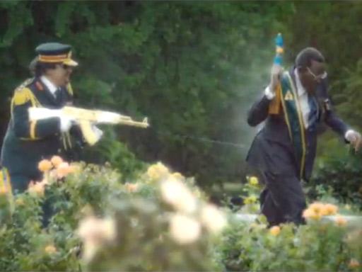 Colonel Gaddafi sprays Robert Mugabe with water in the TV advert