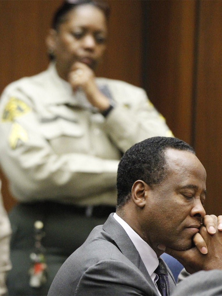 Conrad Murray listens as he is sentenced to four years in county jail; he is expected to serve only two years however