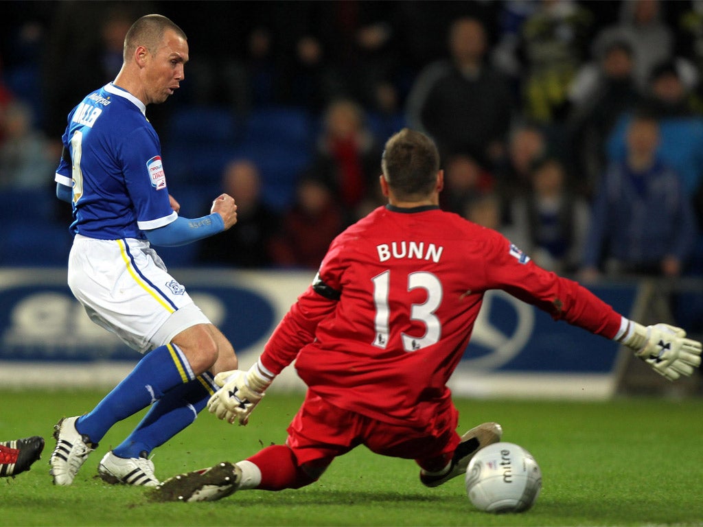 Kenny Miller slips the ball past Mark Bunn to give Cardiff the lead