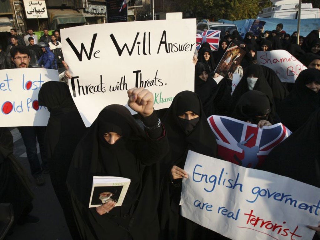 Female Iranian protesters attend an anti-British demonstration in front of the British Embassy, in Tehran, Iran