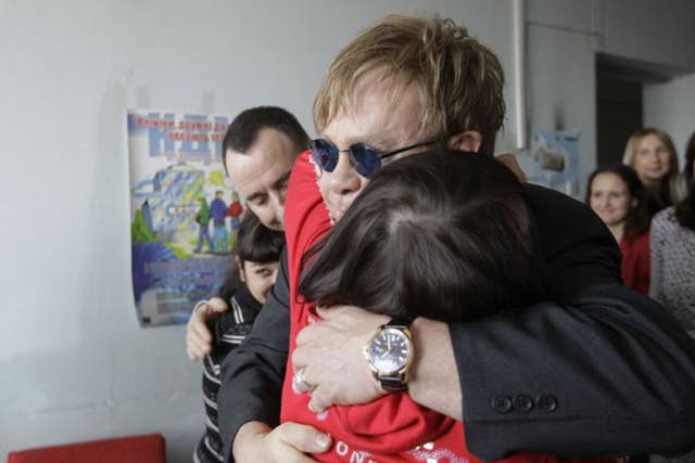 Scenes from Kiev: Elton John hugs a patient at a drop-in centre funded by his Aids Foundation