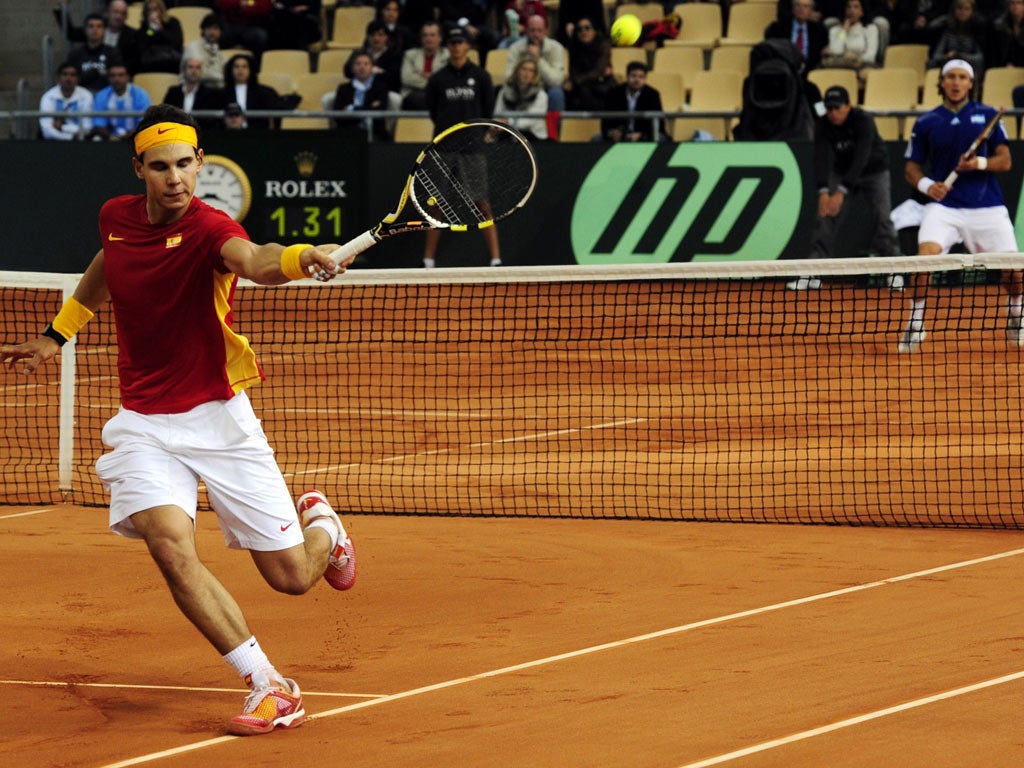 Spain's Rafael Nadal returns a ball to Argentina's Juan Monaco during the Davis Cup final