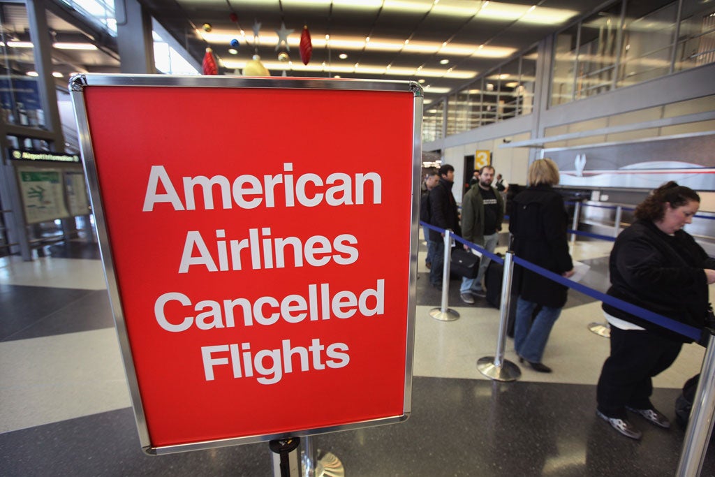 Grounded: American Airlines passengers try to re-book flights