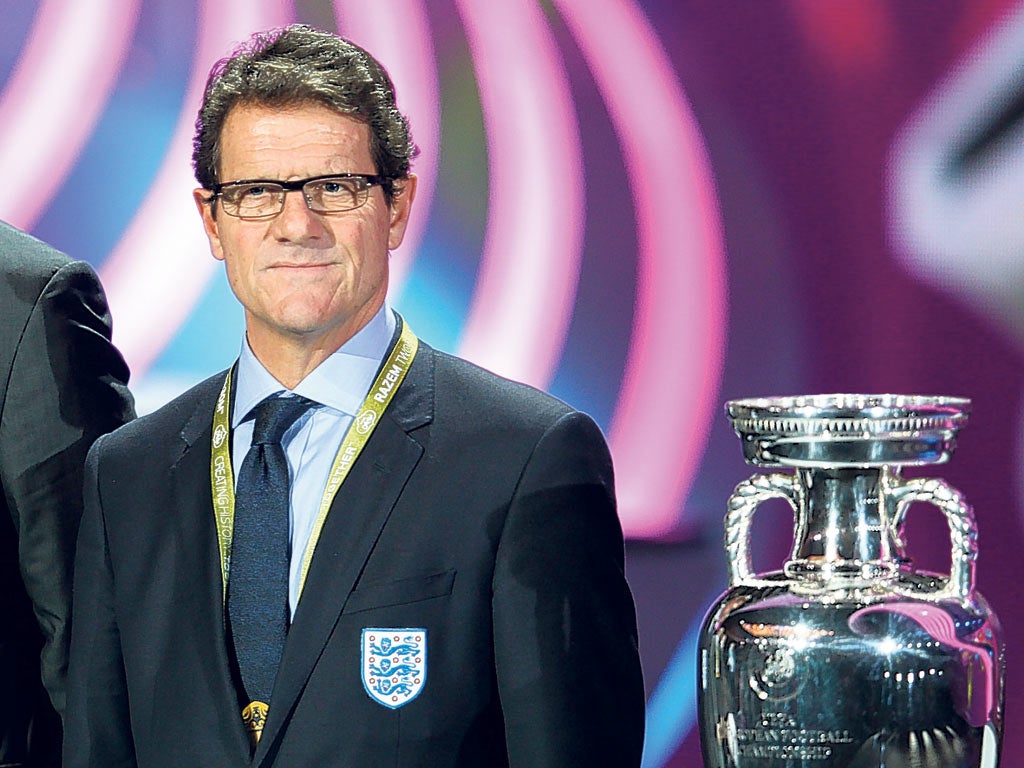 Fabio Capello next to the European Championship trophy in Kiev yesterday.
England will play Ukraine, Sweden and France at Euro 2012