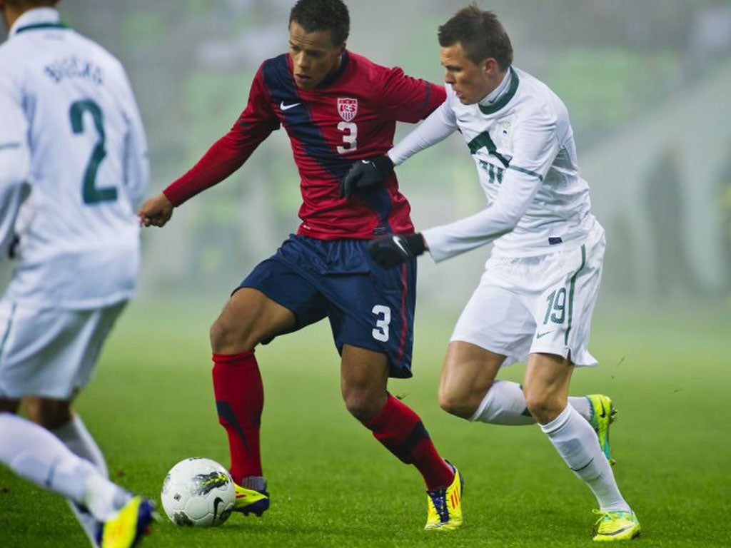 Josip Ilicic of Slovenia (right) chases down Timothy Chandler of the USA.