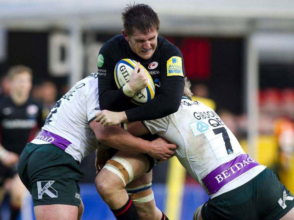 Saracens’ Ernst Joubert is tackled by James Buckland and Jamie Gibson