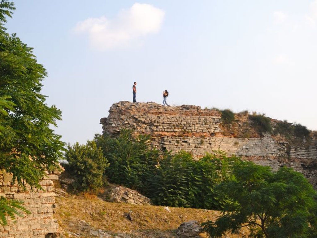 A Turkish couple hike along the Theodosian Walls in Istanbul