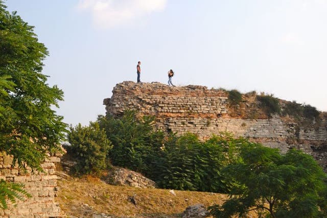 A Turkish couple hike along the Theodosian Walls in Istanbul
