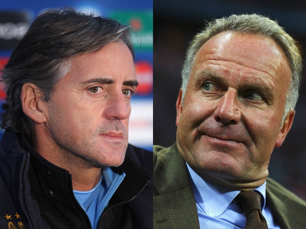 Mancini, left, says he is bemused by Rummenigge's attacks and will raise the issue if he sees him at the Etihad Stadium, where City meet Bayern in their final Champions League Group A match tomorrow