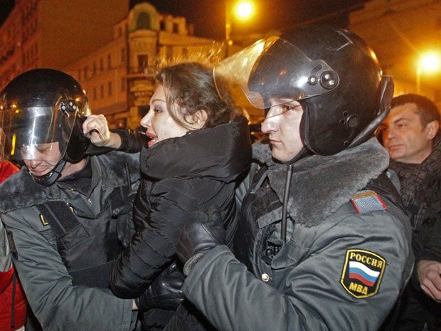 Police detain demonstrators during protests against alleged vote rigging in Russia