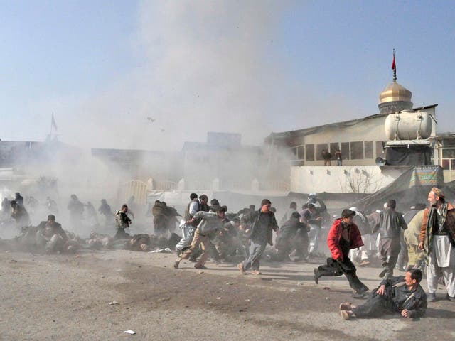 People flee in fear from the explosion in Kabul yesterday which left scenes of carnage and death, after a suicide bomber targeted a Shia shrine, killing 55 worshippers and injuring 134