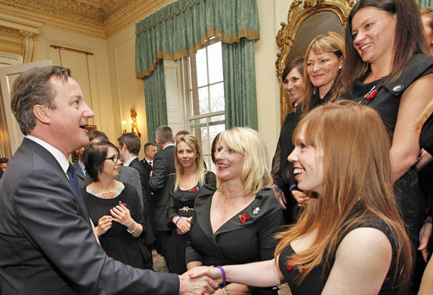 Mr Cameron meets a military wives' choir at a Downing Street reception yesterday