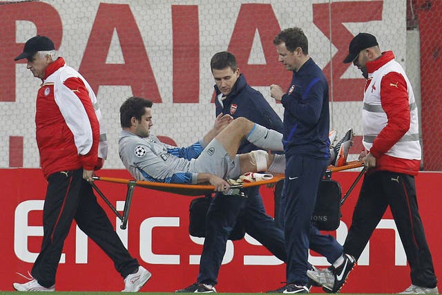 Arsenal's goalkeeper Lukasz Fabianski is carried from the pitch last night