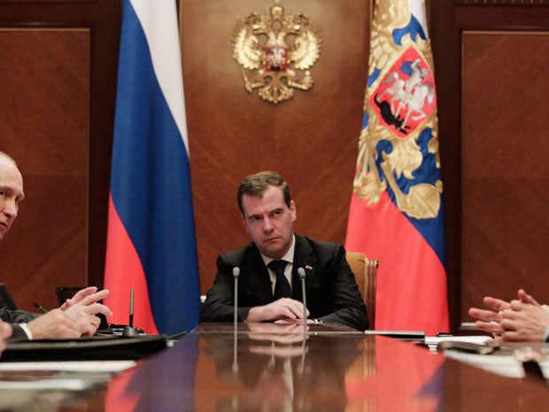 Russian President Dmitry Medvedev, centre, and Prime Minister Vladimir Putin, second left, attend a Security Council meeting today