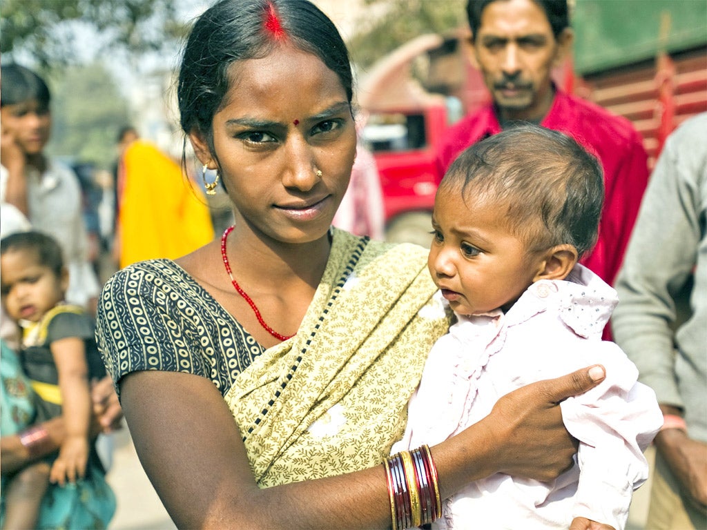 Payal Devi with her baby by Save The Children's mobile clinic in Okhla