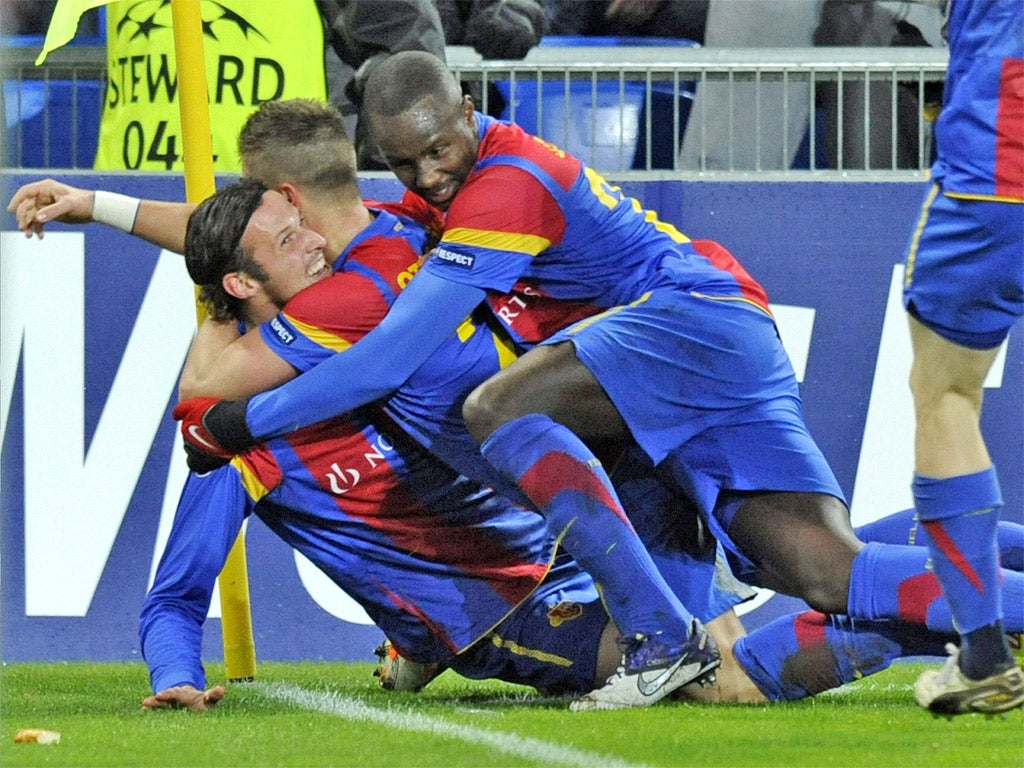 Basle striker Marco Streller is mobbed after putting the Swiss 1-0 up last night