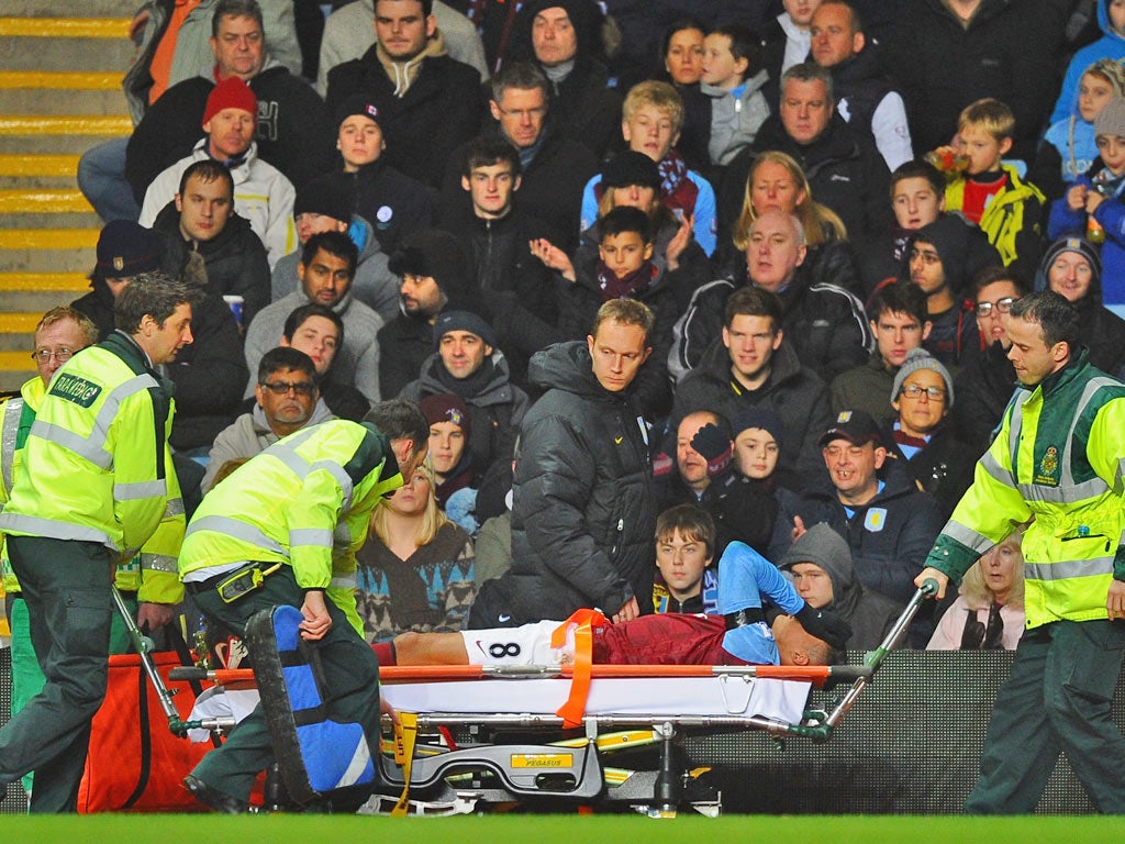 Jermaine Jenas is stretchered off on his debut against Manchester United at Villa Park