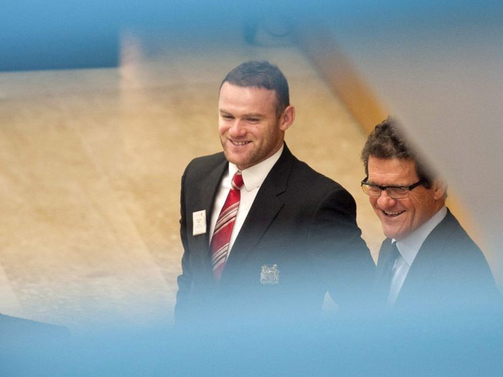 Rooney (and Capello) are all smiles at the hearing in Nyon yesterday
