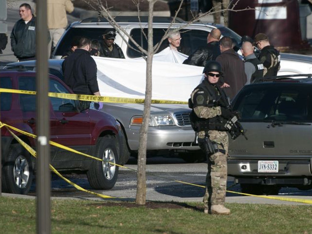 Police examine the body of an officer shot dead at Virginia Tech