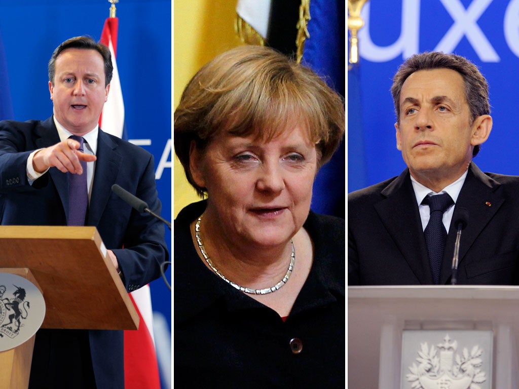 David Cameron, Angela Merkel and Nicolas Sarkozy at the summit last night