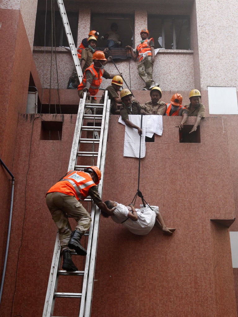 Fire fighters evacuate a patient from the hospital