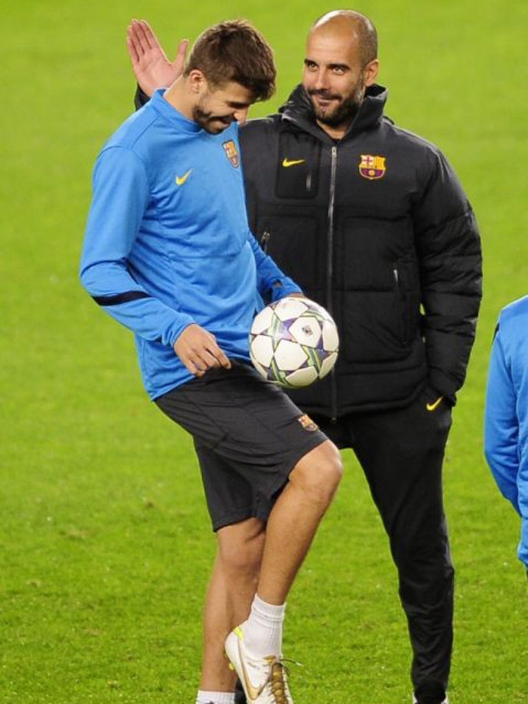 Pep Guardiola (right) shares a joke with Gerard Pique this week