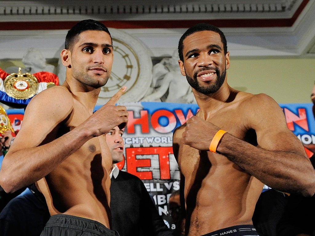AmirKhan (left) and Lamont Peterson at the weigh-in in Washington
yesterday