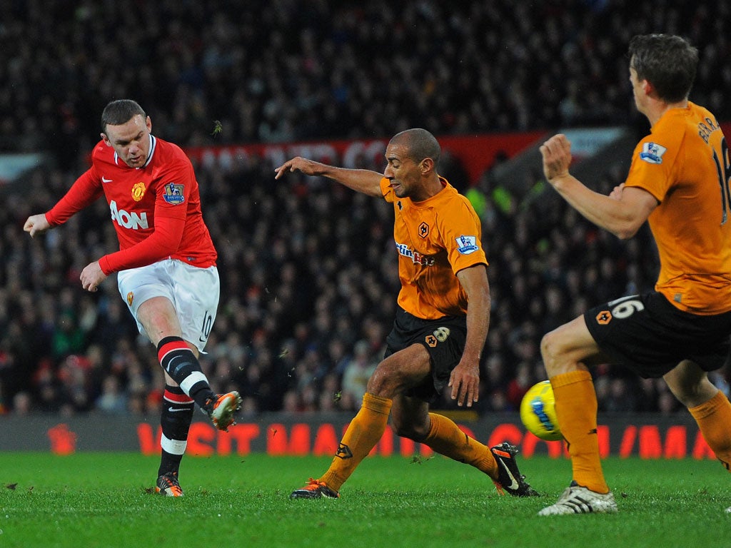 Wayne Rooney (L) shoots past Wolverhampton Wanderers' English midfielder Carl Henry (2nd R) and Scottish defender Christophe Berra (R) to score 